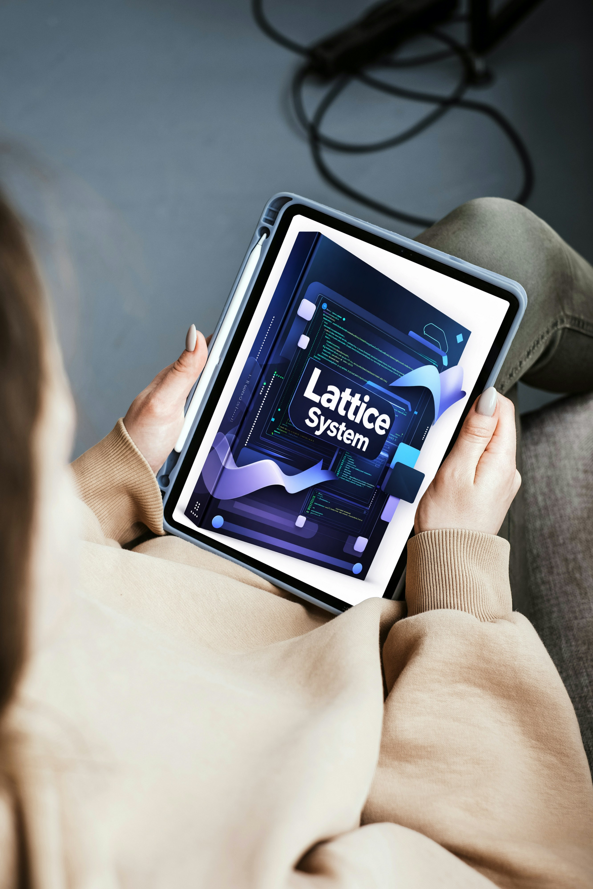 A girl holding a tablet device displaying a digital cover titled lies on a black rectangular stand against a brushed gray metal surface.